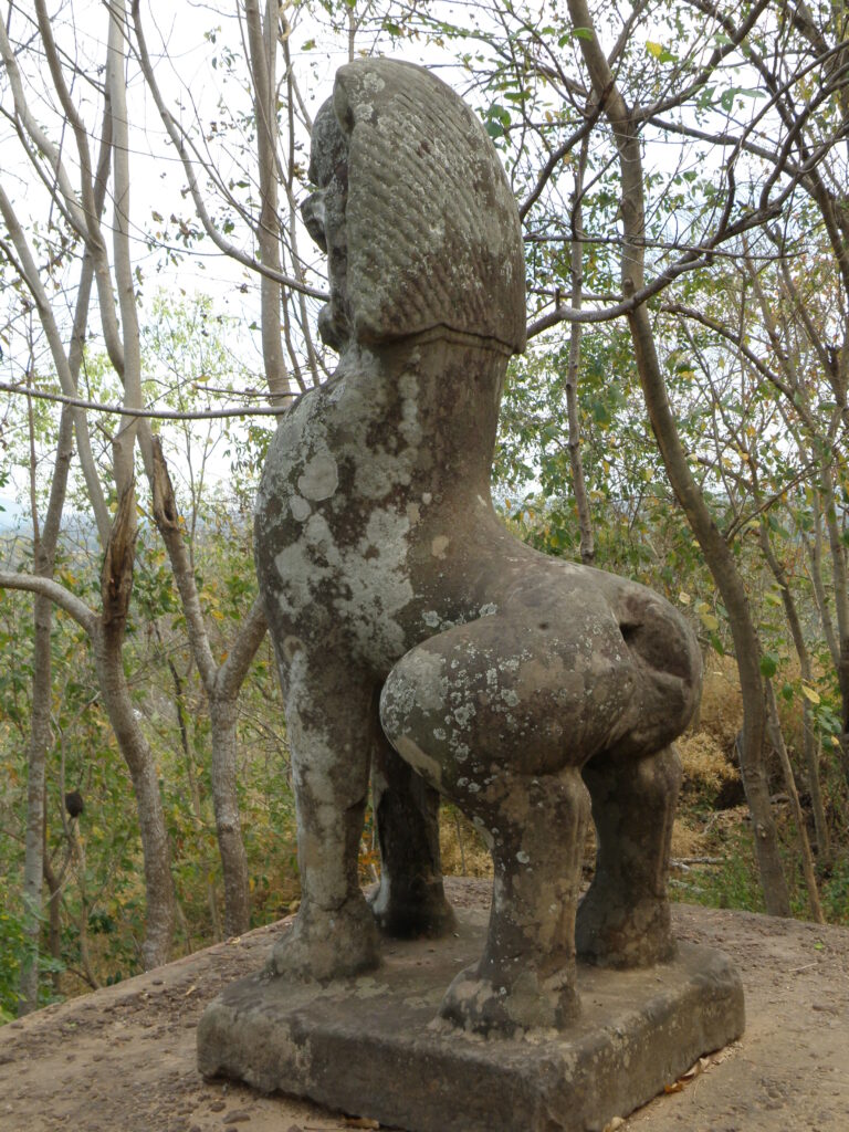 A stone lion guarding the approach to Wat Banan, Battambang, Cambodia